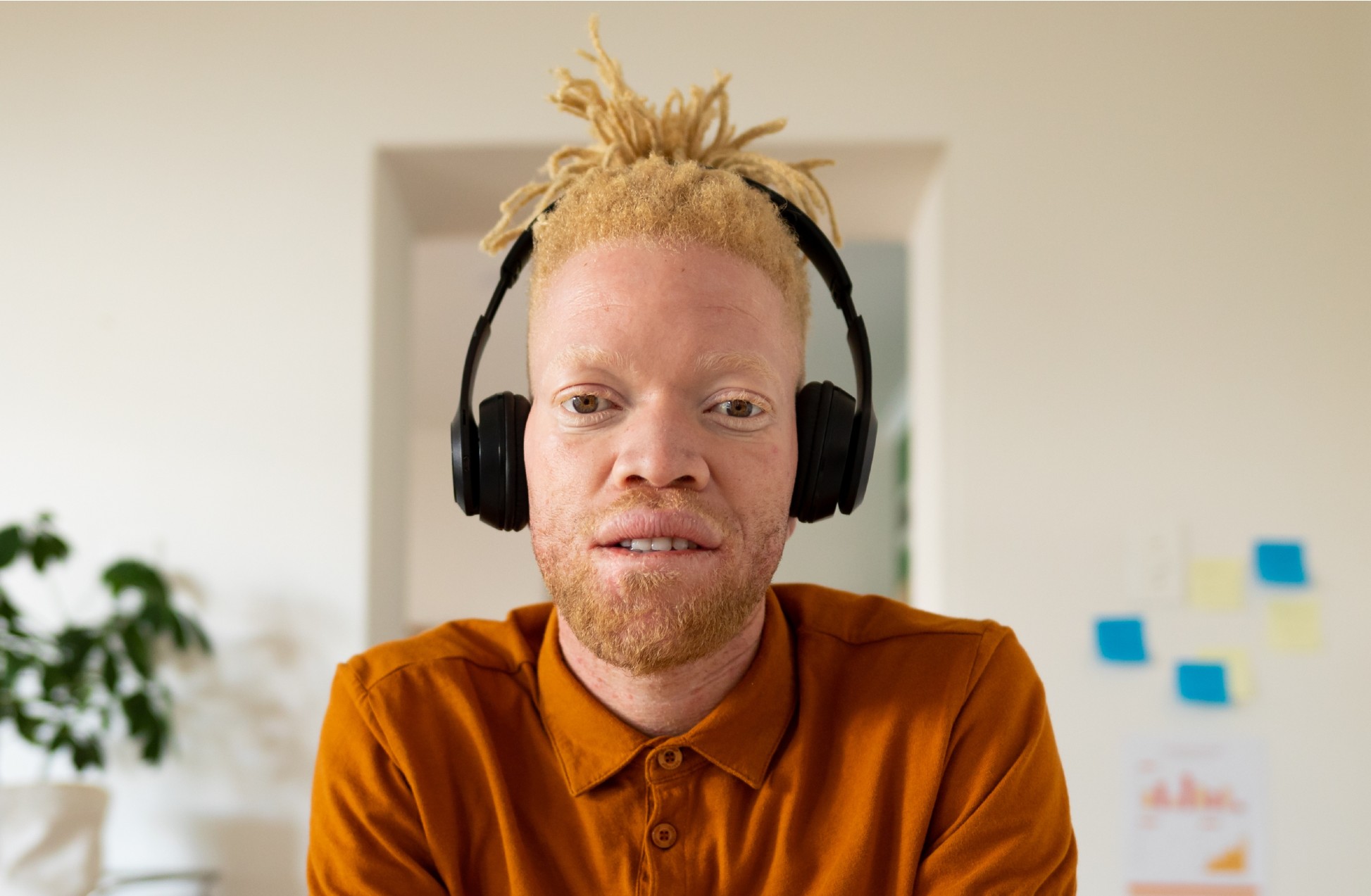 Young man with Albinism wearing a headset